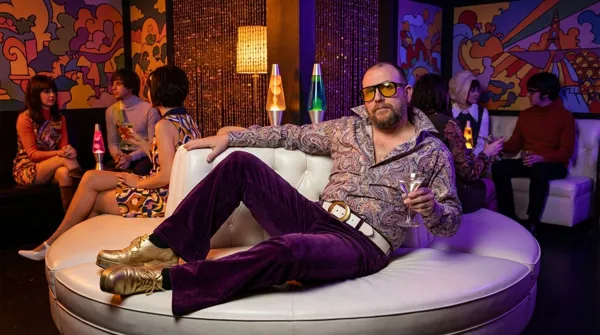 Groovy man lounging in a psychedelic 1960s club