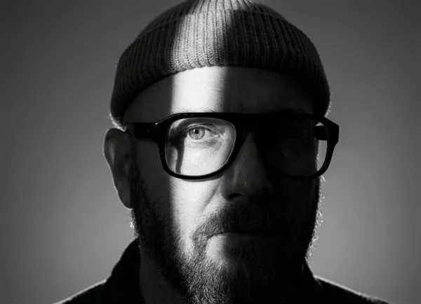 Dramatic black and white close-up portrait with stark lighting