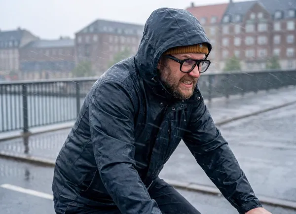 Lone Cyclist Battling Storm on Copenhagen Bridge